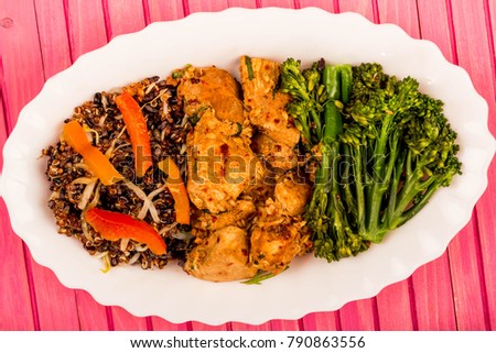 Soy Ginger and Lime Chicken With Red Quinoa and Vegetables Against A Pink Background