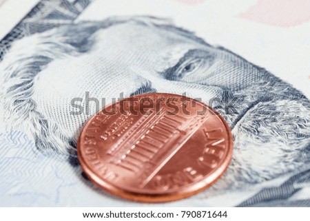 one American cent, lying on an American bill fifty dollars, a close-up photo