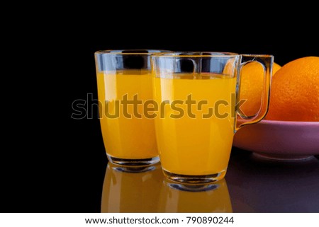 Orange juice - two glasses with oranges on black background