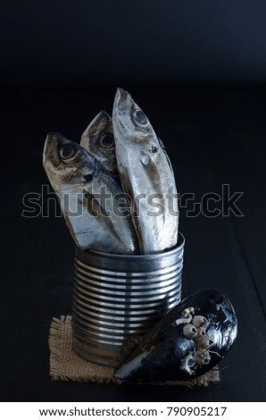 Canned fresh fish on a dark wooden bottom. Mackerel.