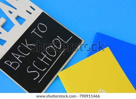 board for chalk and notebook on a blue background
