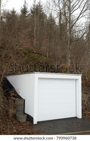 the white concrete garage built into the mountain
