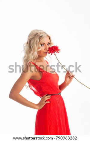 Beautiful young woman wearing a red dress with a red flower