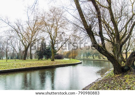 late autumn in the city Park: the Bare trees, the river, benches