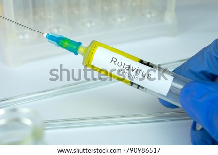 Vaccination healthcare concept. Hands of doctor or nurse in medical gloves with medical syringe ready for injection a shot of Rotavirus vaccine. close up, selective focus Royalty-Free Stock Photo #790986517