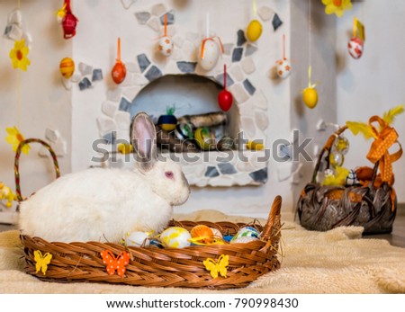 Easter bunny with eggs in a basket  and fireplace 
