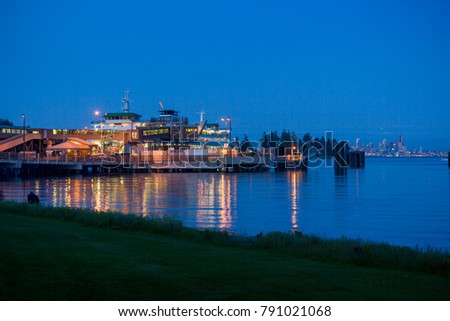 Ferry dock at Bainbridge Island with skyline of Seattle in the background, WA, USA Royalty-Free Stock Photo #791021068