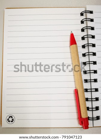 Top view of spiral blank notebook with pen