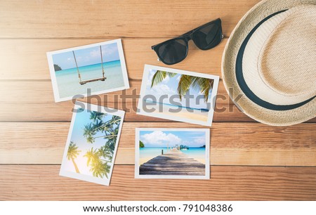 Top view summer photo album on wood table,summer tourism, travel concept.