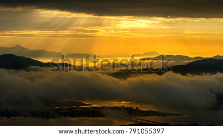 Golden light at mountains is covered by morning fog and sunrise in Seoul,Korea.