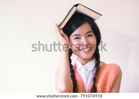 Portrait of Young cute asian woman  holding a book