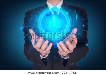 Businessman holding the glowing bitcoin currency digital icon and world map background as business, innovation, intelligent, investment, stock and income concept.