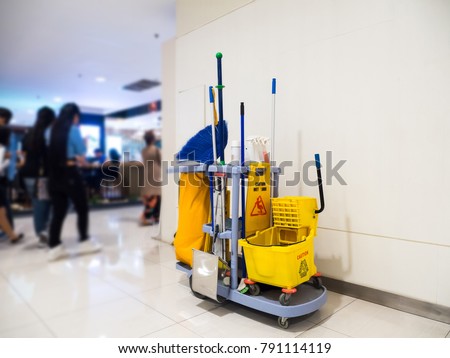 Cleaning tools cart wait for cleaning.Bucket and set of cleaning equipment in the Department store. cleaning service concept Royalty-Free Stock Photo #791114119