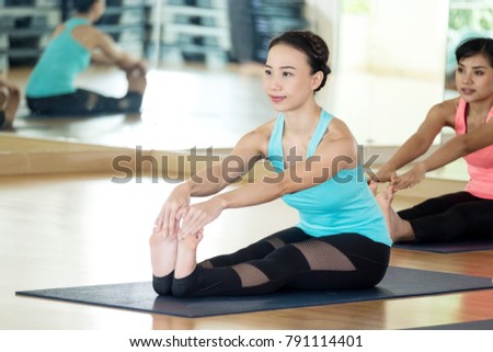 Young asian women practicing yoga.