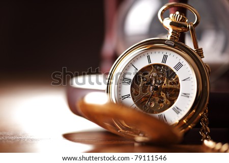 Vintage pocket watch and hour glass or sand timer, symbols of time with copy space Royalty-Free Stock Photo #79111546