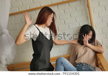 two women fighting, slapping, hitting, catfight, concept of domestic violence,  physical assault crime Royalty-Free Stock Photo #791154301