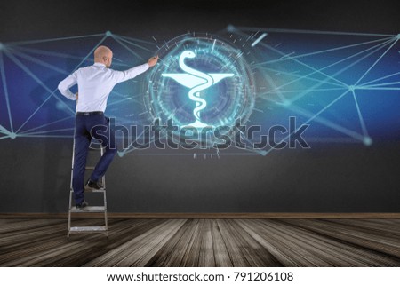 View of a Businessman in front of a wall with pharmacy medical icon on a futuristic interface 