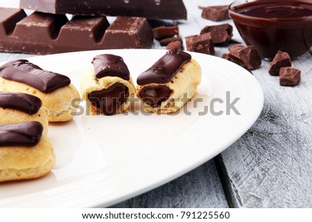Traditional French dessert. Eclair with chocolate icing. Pastery concept