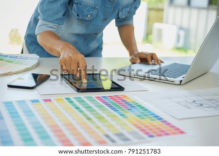 Graphic design and color swatches and pens on a desk. Architectural drawing with work tools and accessories
