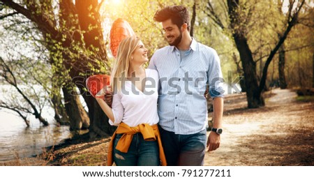 Picture of romantic couple standing outside with baloons