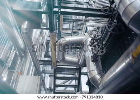 Equipment, cables and piping as found inside of a modern industrial power plant

