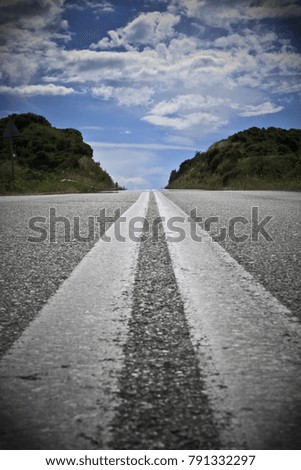 A road heading to the sky through the hills