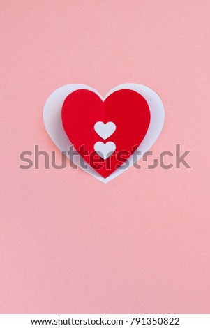 Red paper heart on the pink background. Valentine's or Wedding's day postcard concept. Toned.