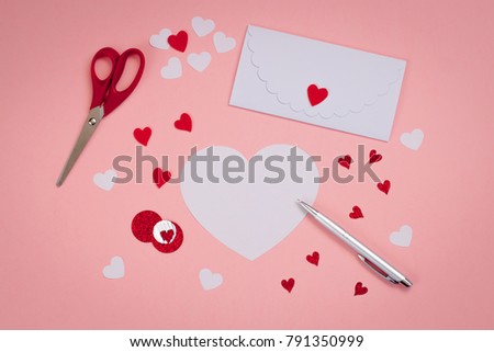 Signing Handmade Valentine cards with Felt, silver pen. white envelope. Toned.