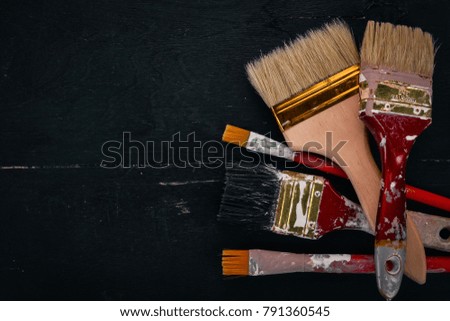 Brushes on a black wooden background. Art. Free space for text. Top view.