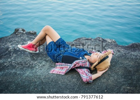 Cute girl sleeping on the rock in nature , Relax time on holiday concept travel,selective and soft focus,tone of hipster style