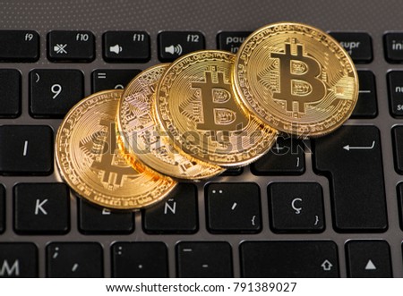 Bitcoin coins on laptop keyboard. Cryptocurrency