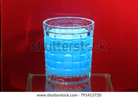 Transparency Colorful fruit juice in glass on red background
