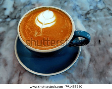 Blue cup coffee latte art on marble table, have copy space 