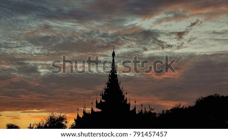 Beautiful sunset at Mandalay palace with multicolour clouds in the sky.