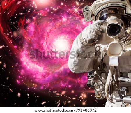 Astronaut with a camera makes a photo. The elements of this image furnished by NASA.
