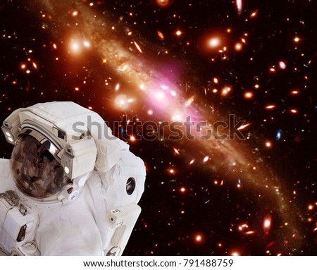 Astronaut and galaxies, starfield. The elements of this image furnished by NASA.