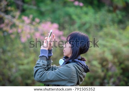 Girl shooting picture and happy with Wild Himalayan Cherry Blossom