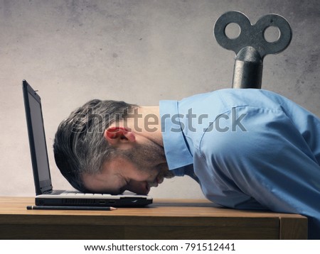 Handsome business man sleeping on a laptop 