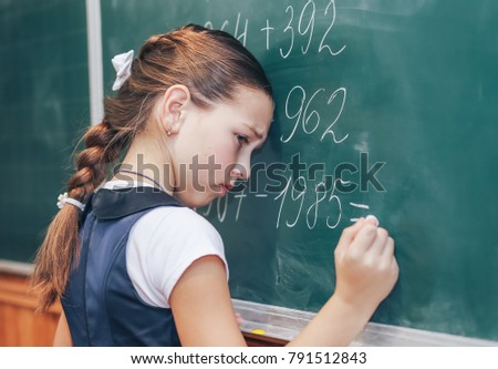 The schoolboy at the blackboard can not solve the problem. Problems with know in school Royalty-Free Stock Photo #791512843