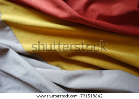 Draped orange, yellow and beige jersey fabric