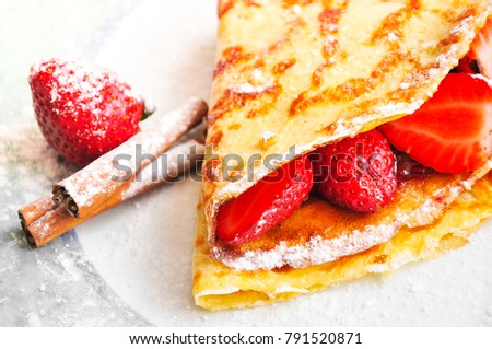 Strawberry pancake sprinkled with fine sugar