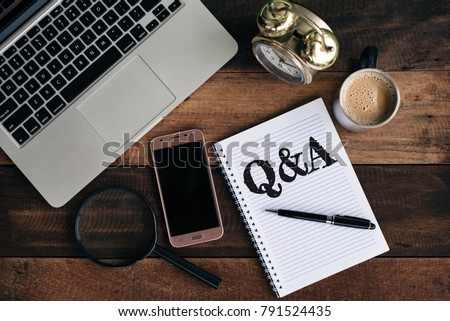 laptop, clock, phone, magnifying glass, coffee and notebook with Q&A word. Questions and answer concept Royalty-Free Stock Photo #791524435