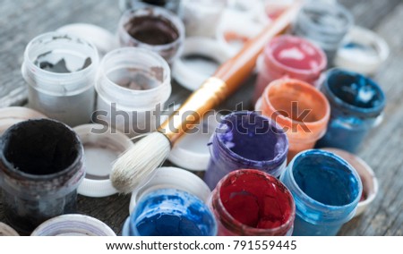 brush and colored water paints on a wooden table