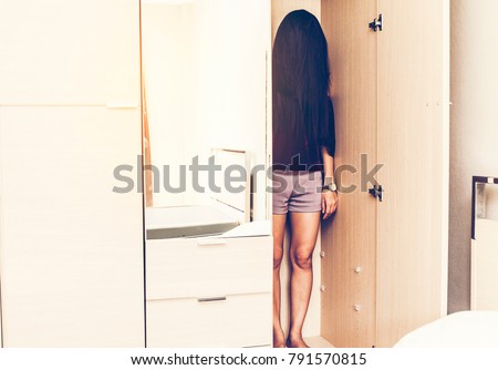 Depressed Asian woman or corpse stand in closet ,sad girl, cry, mystery,murder,violence and drama concept. Ghost, Mysterious woman, Horror scene and scary concept