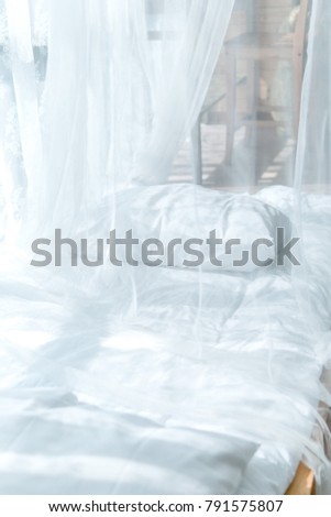 white bed sweet with light sun at evening. rest, interior, comfort and bedding concept - bed at home bedroom