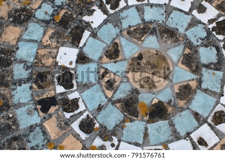 rustic mosaic coloured tiles on table in garden