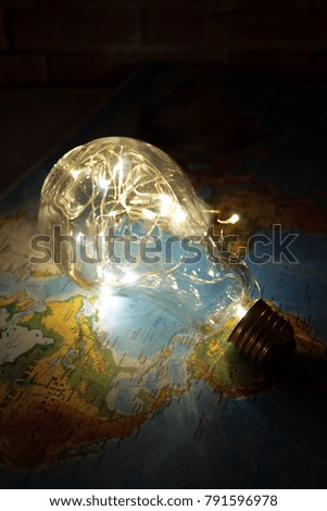 Light Bulb on World Map Background.