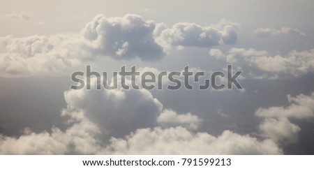Clouds white and grey on dark blue sky background. Aerial photo from plane's window