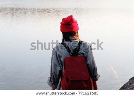 Traveler young girl with red hat and backpack walking on path in the tropical forest, Relax time on holiday concept travel, Thailand.