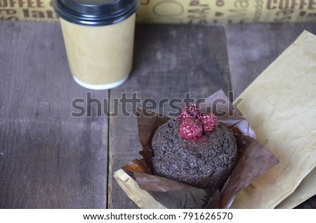 Take away coffe (to go) and chocolate muffin with copy space for text or advert. The concept of a bakery, coffee houses. Breakfast, snacks